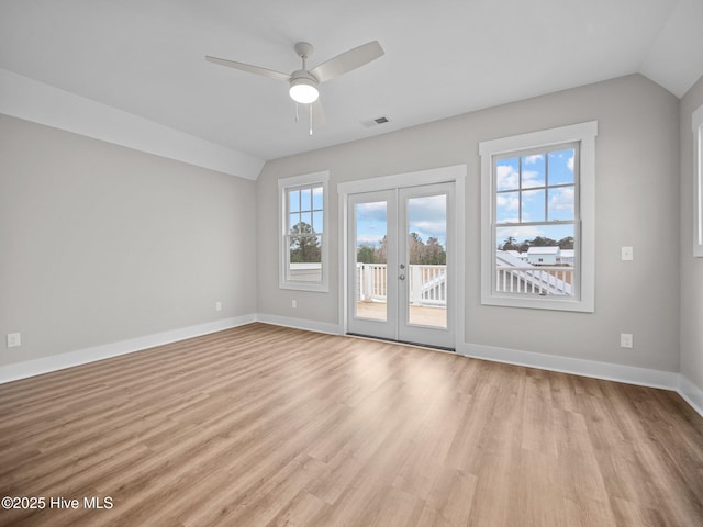 unfurnished room with french doors, light hardwood / wood-style flooring, vaulted ceiling, and ceiling fan