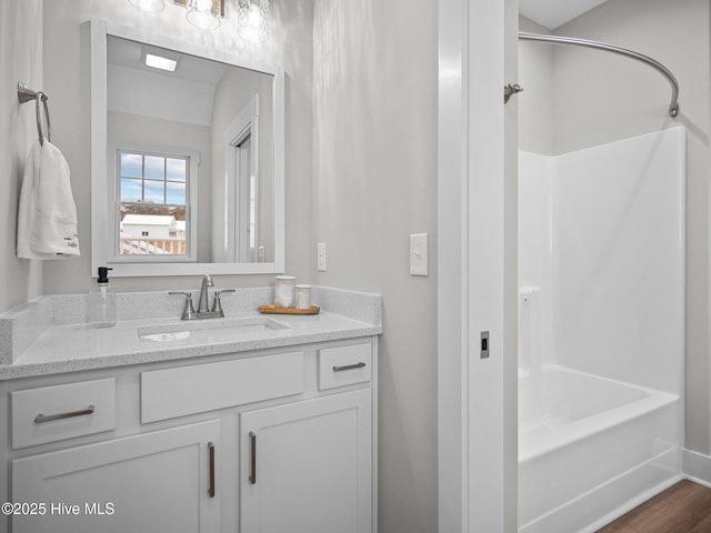 bathroom featuring vanity, shower / bathtub combination, and hardwood / wood-style flooring