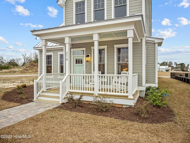 view of front of property with a front lawn and covered porch