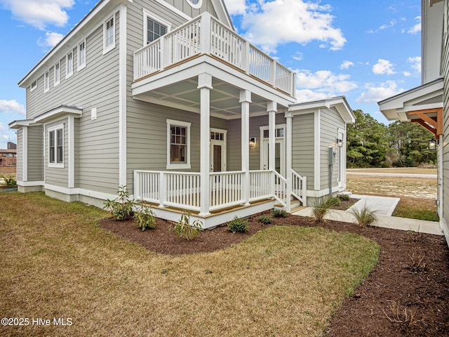 view of property exterior with a lawn and a balcony