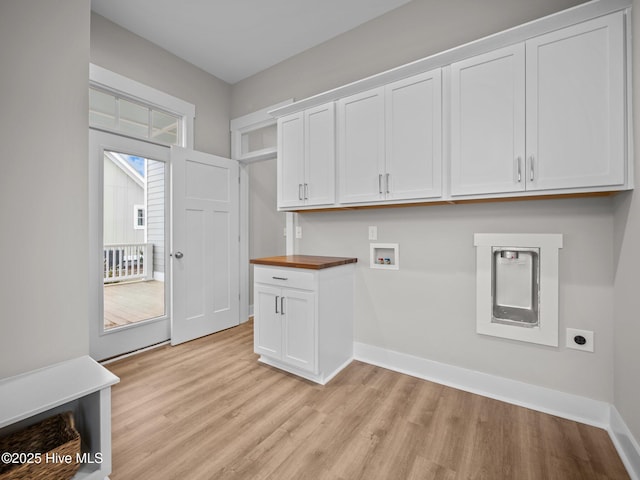 laundry area with hookup for an electric dryer, cabinets, a wealth of natural light, and washer hookup