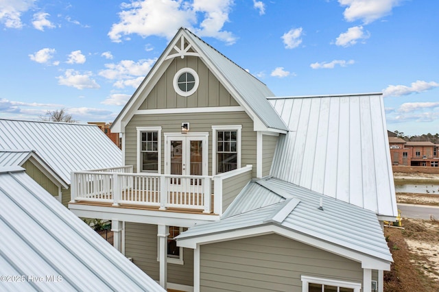 back of house with a balcony and french doors