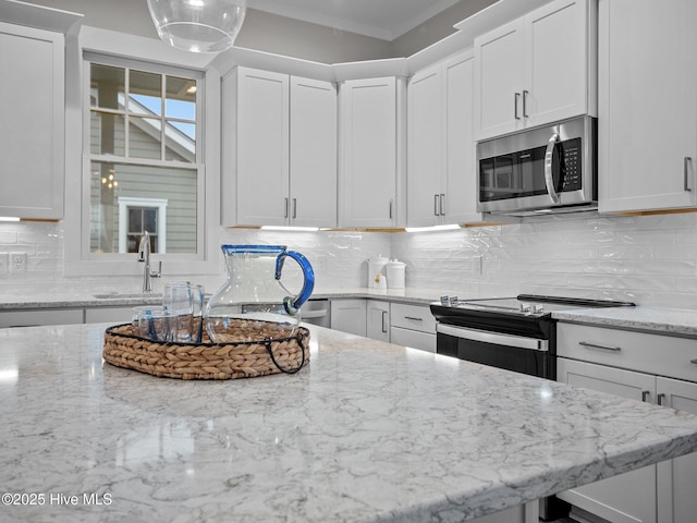 kitchen with tasteful backsplash and white cabinets