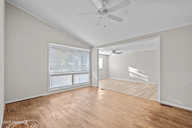 unfurnished living room featuring visible vents, vaulted ceiling, and wood finished floors