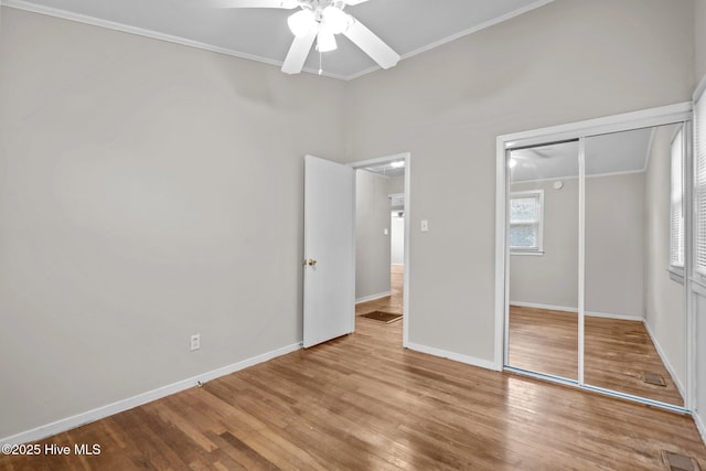 unfurnished bedroom with light wood-type flooring, a closet, visible vents, and baseboards