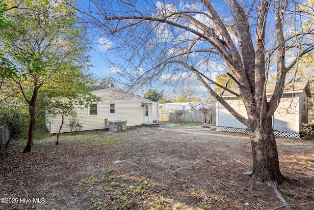 view of yard featuring fence and central air condition unit