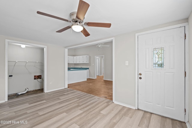 foyer with light wood-style floors and baseboards