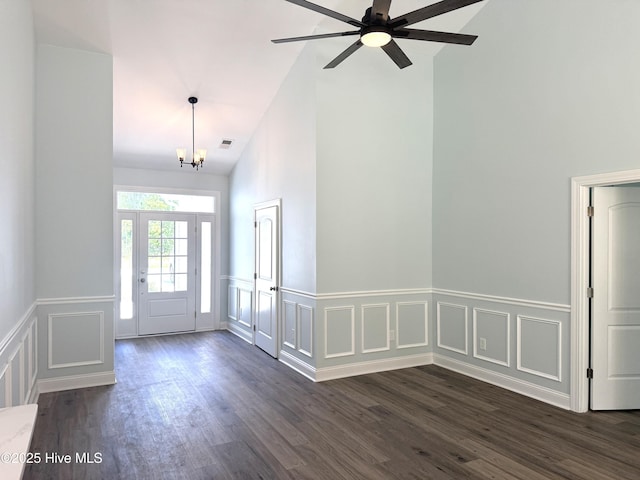 657 Boundary Loop NW, Carolina Shores, NC 28467 - foyer featuring high vaulted ceiling, a decorative wall, dark wood finished floors, wainscoting, and a chandelier