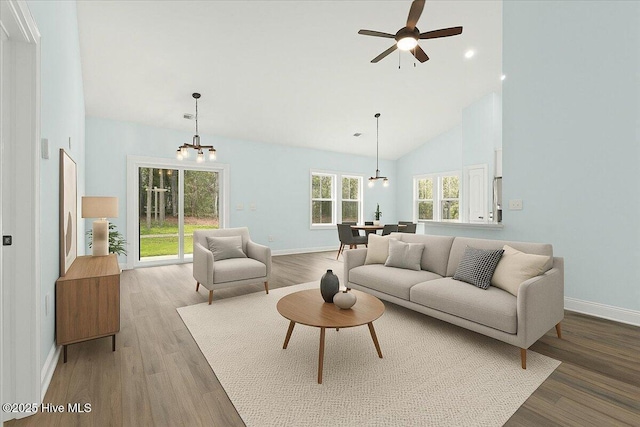 657 Boundary Loop NW, Carolina Shores, NC 28467 - living room featuring light wood-style flooring, baseboards, a chandelier, high vaulted ceiling, and ceiling fan