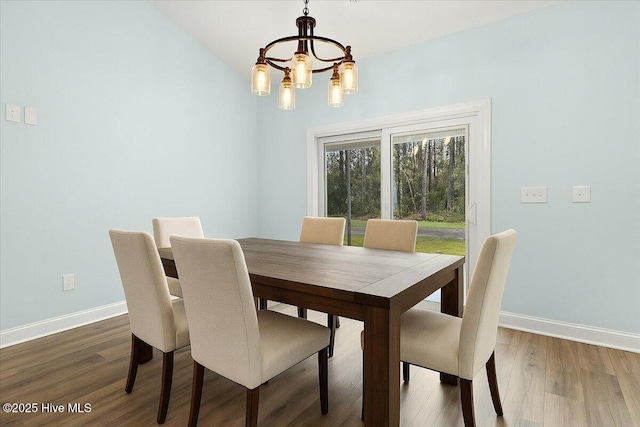 657 Boundary Loop NW, Carolina Shores, NC 28467 - dining area with a chandelier, wood finished floors, and baseboards