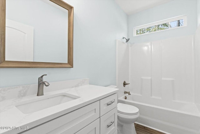 full bathroom with  shower combination, toilet, and vanity