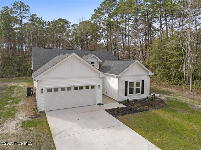 view of front of house featuring a garage, a front yard, and cooling unit