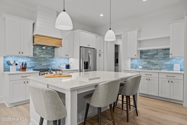 kitchen featuring pendant lighting, white cabinetry, and stainless steel fridge with ice dispenser