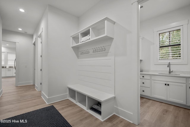 mudroom with sink and light wood-type flooring