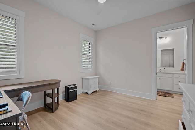 office space featuring light hardwood / wood-style floors and sink