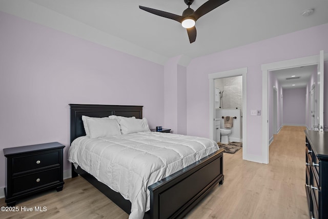 bedroom featuring ceiling fan, light hardwood / wood-style floors, and connected bathroom