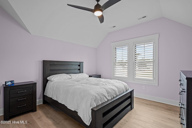 bedroom with ceiling fan, light hardwood / wood-style flooring, and vaulted ceiling