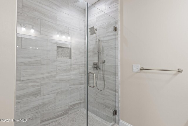 bathroom featuring a shower with door