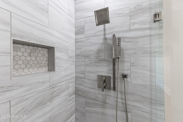 bathroom with a tile shower