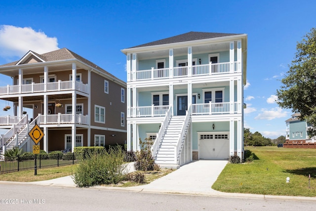 coastal home featuring a garage, a front lawn, and a porch