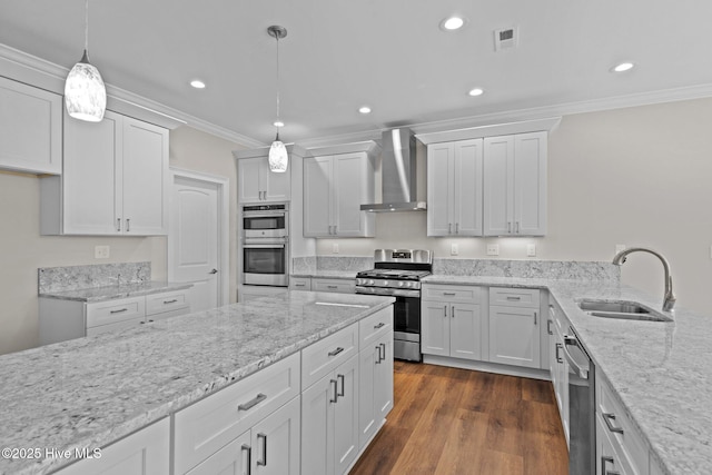 kitchen featuring decorative light fixtures, sink, white cabinetry, stainless steel appliances, and wall chimney exhaust hood