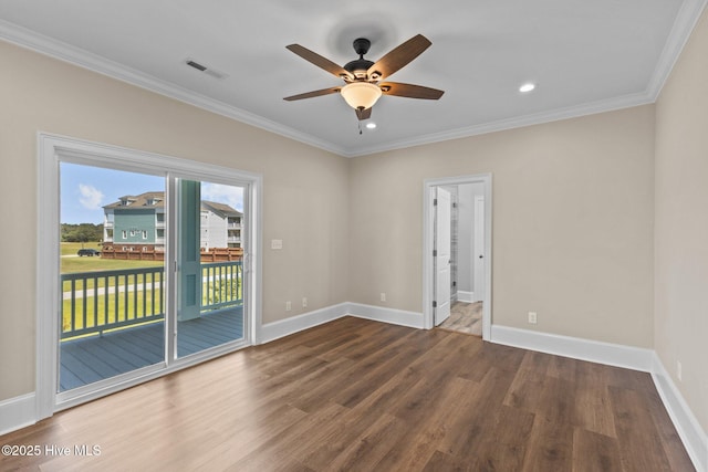 empty room with ceiling fan, dark wood-type flooring, and ornamental molding