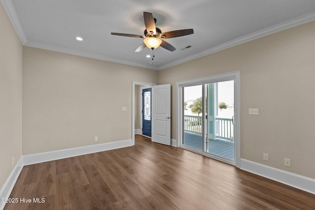 empty room with ceiling fan, dark hardwood / wood-style flooring, and ornamental molding