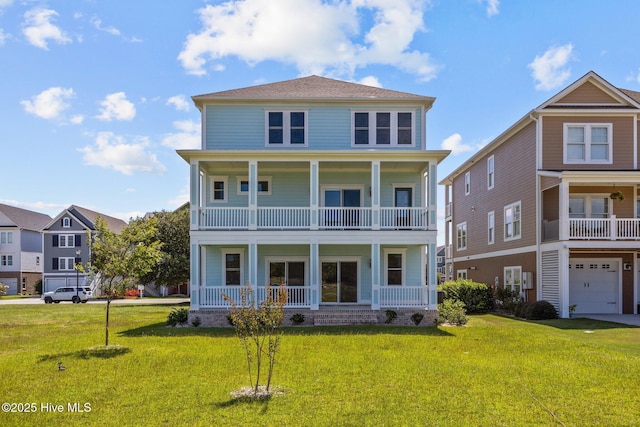 view of front facade featuring a front yard and a balcony