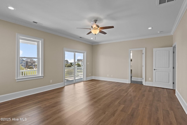 spare room featuring ceiling fan, dark hardwood / wood-style flooring, and crown molding