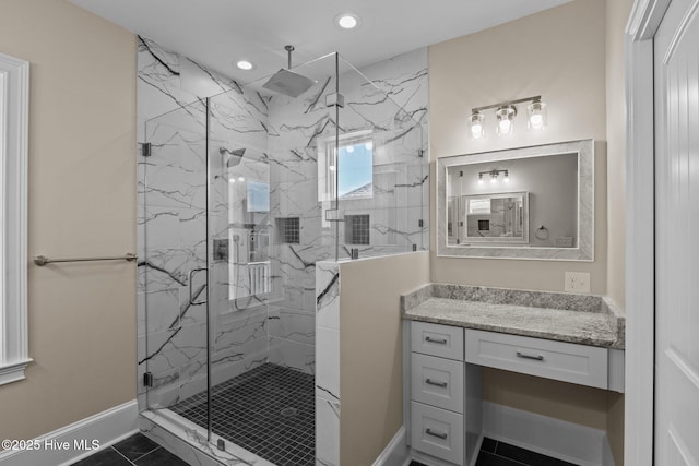 bathroom featuring tile patterned flooring, a shower with shower door, and vanity