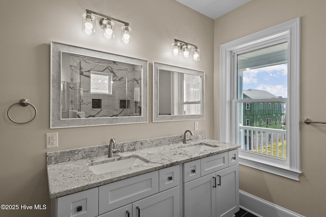 bathroom featuring a shower, plenty of natural light, and vanity