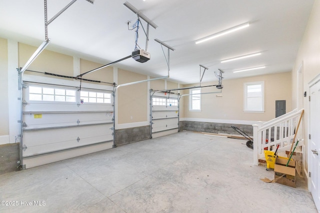 garage featuring electric panel and a garage door opener