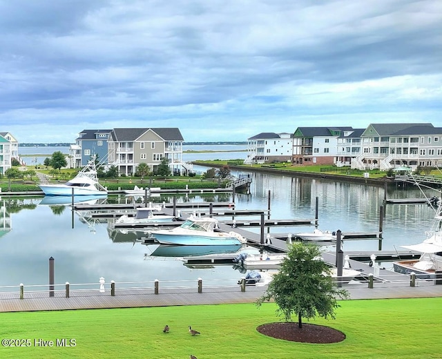 dock area featuring a water view and a lawn