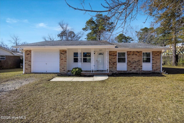 ranch-style house featuring a garage and a front yard