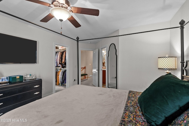 bedroom featuring ceiling fan, a closet, and a spacious closet