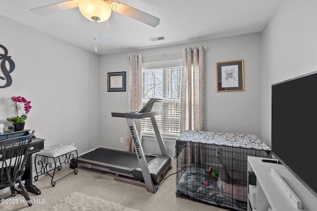 exercise room with light carpet and ceiling fan