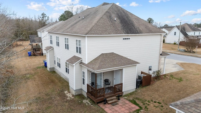 rear view of property featuring a porch