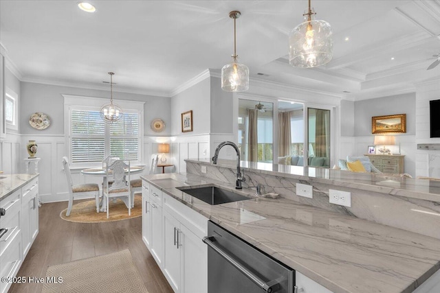 kitchen with dishwasher, light stone counters, sink, and hanging light fixtures