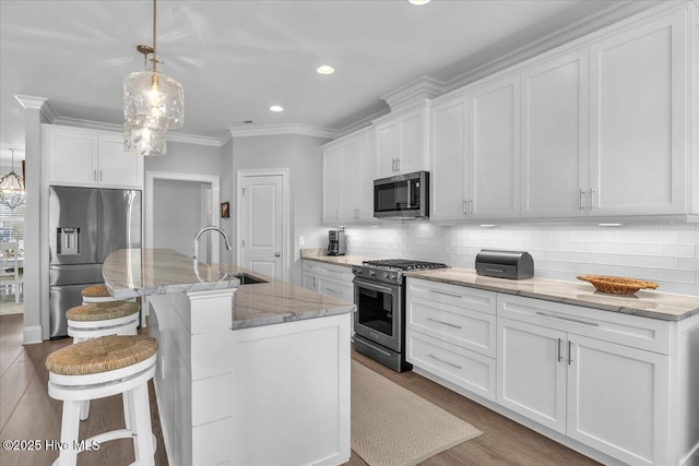 kitchen with white cabinetry, sink, a center island with sink, and appliances with stainless steel finishes