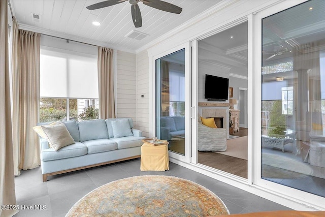 sunroom / solarium with beamed ceiling, ceiling fan, and coffered ceiling