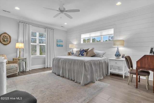 bedroom with ceiling fan, light hardwood / wood-style flooring, and crown molding