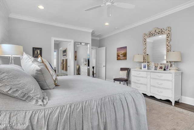 bedroom with hardwood / wood-style flooring, ceiling fan, and ornamental molding