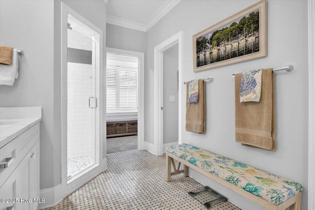 bathroom featuring tile patterned flooring, vanity, crown molding, and walk in shower