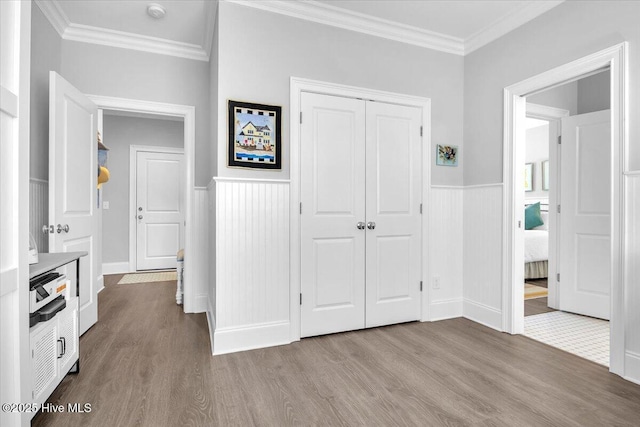 unfurnished bedroom featuring a closet, light wood-type flooring, and ornamental molding