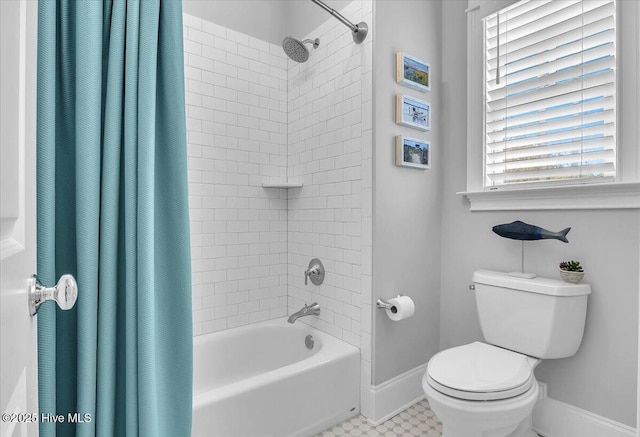 bathroom featuring shower / bath combo and toilet