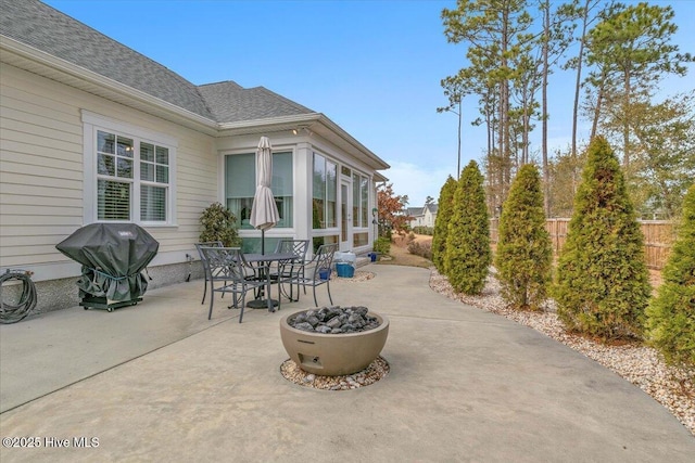 view of patio with grilling area and a fire pit