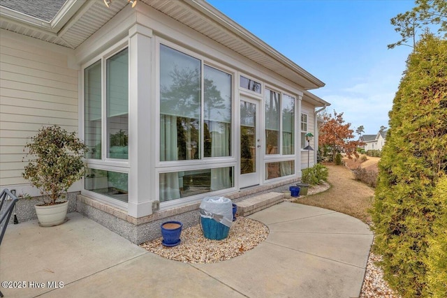 view of side of home with a patio area