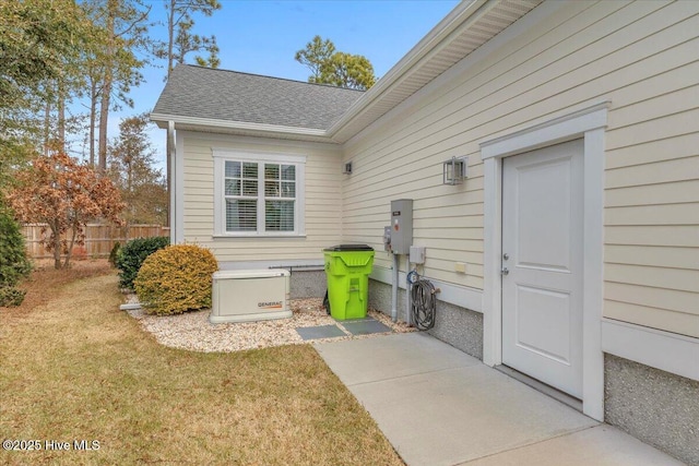 entrance to property featuring a lawn and a patio