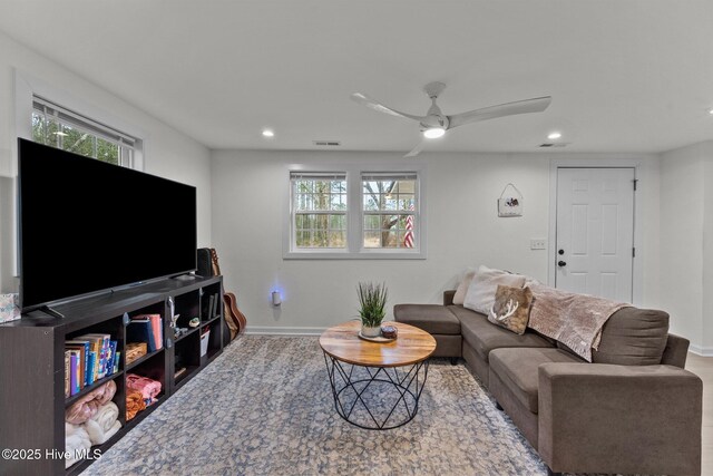 living room featuring ceiling fan and light hardwood / wood-style floors