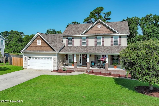 view of front of house featuring a front yard, a porch, and a garage